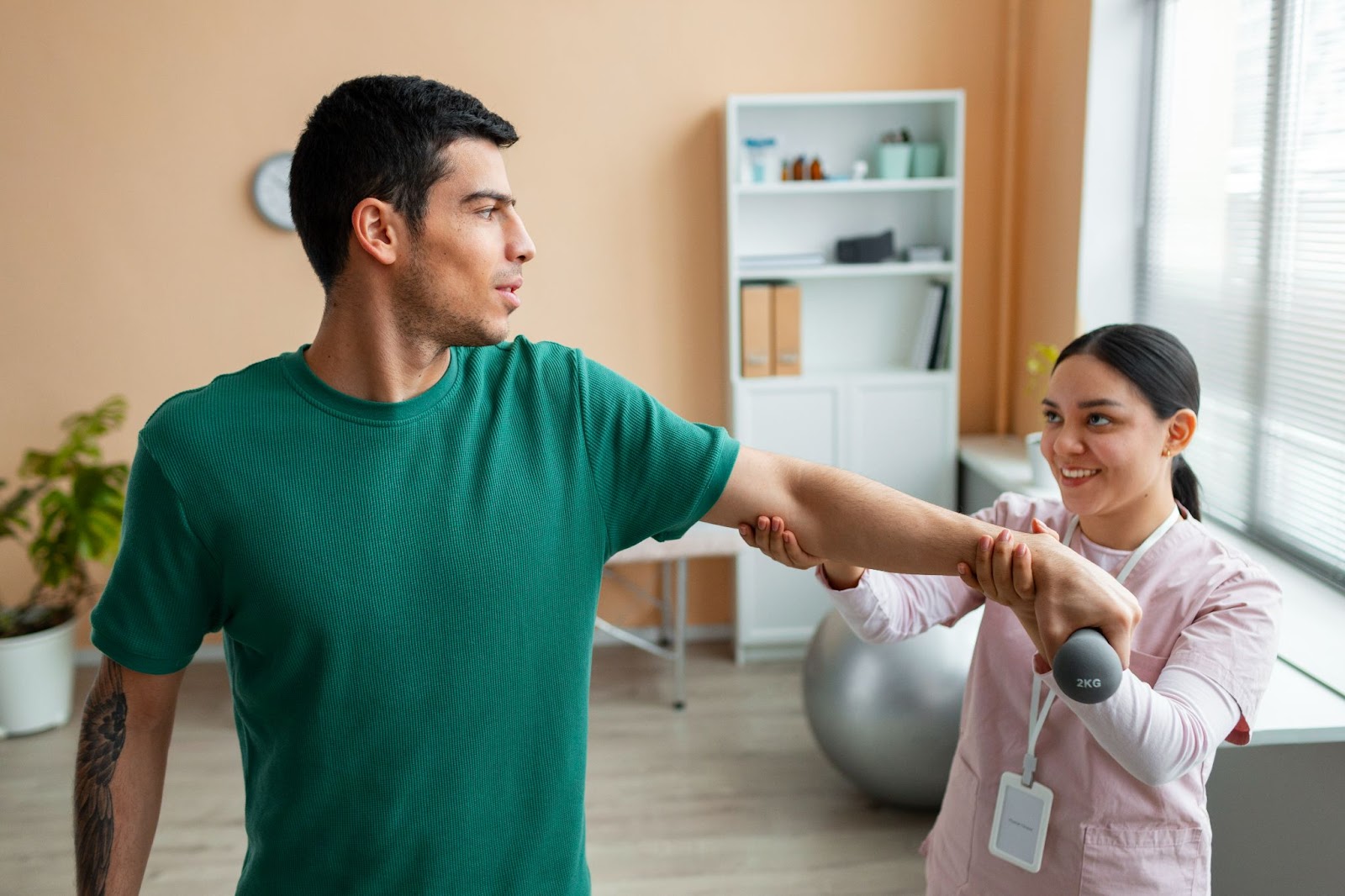Occupational therapist assisting patient with arm movement in occupational therapy